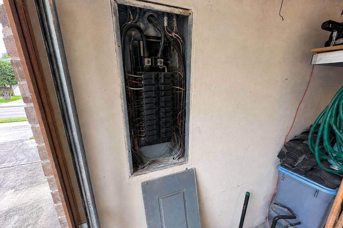 Breaker panel with the dead front removed, breakers and branch wiring visible inside