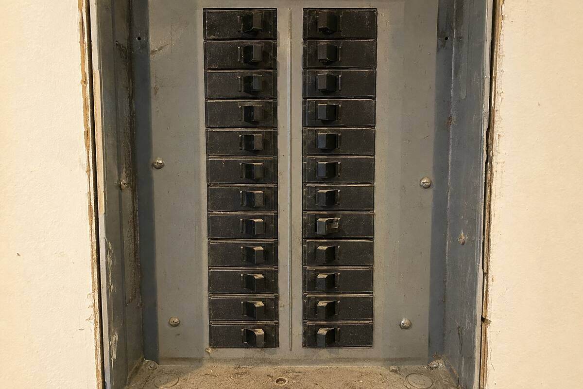 Row of breakers in a panel with one handle sitting between the on and off positions